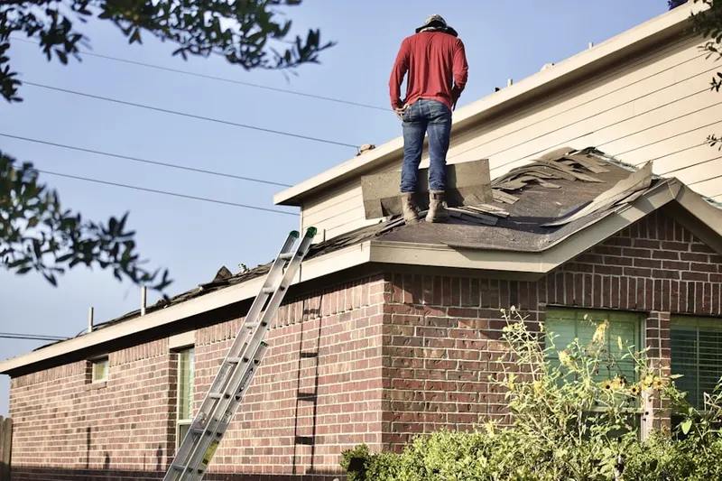 Professional roofer working on a residential roof in La Buena Vida